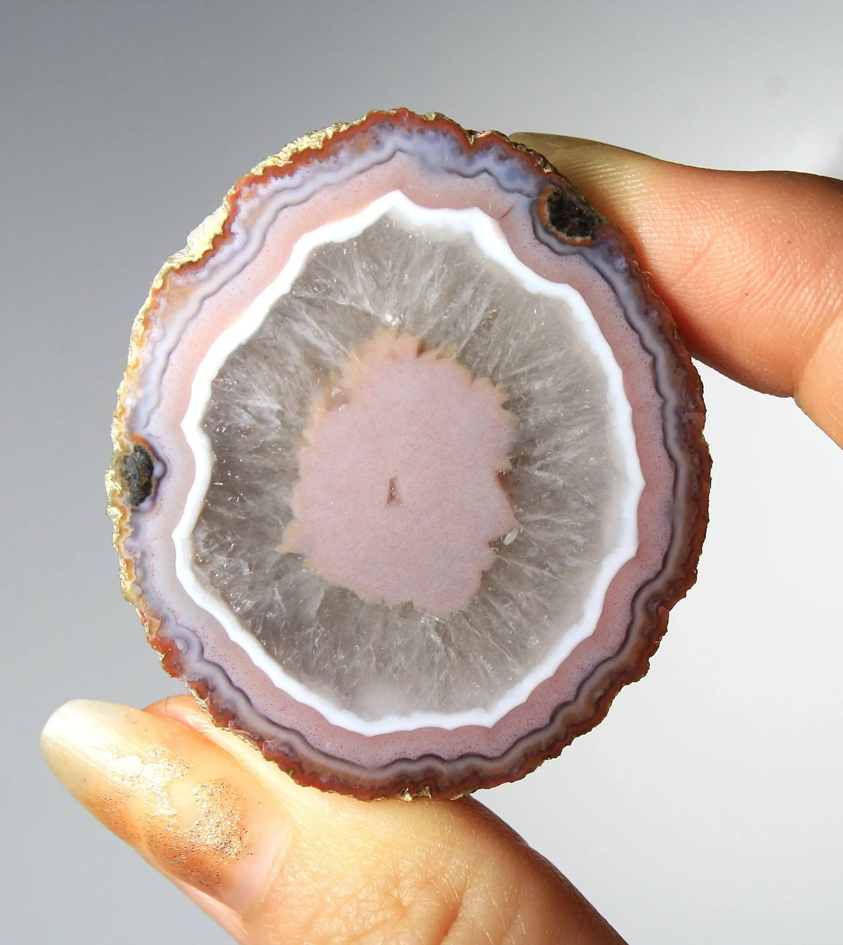 Vibrant pink Zhanguo agate pair with luminous, swirling bands