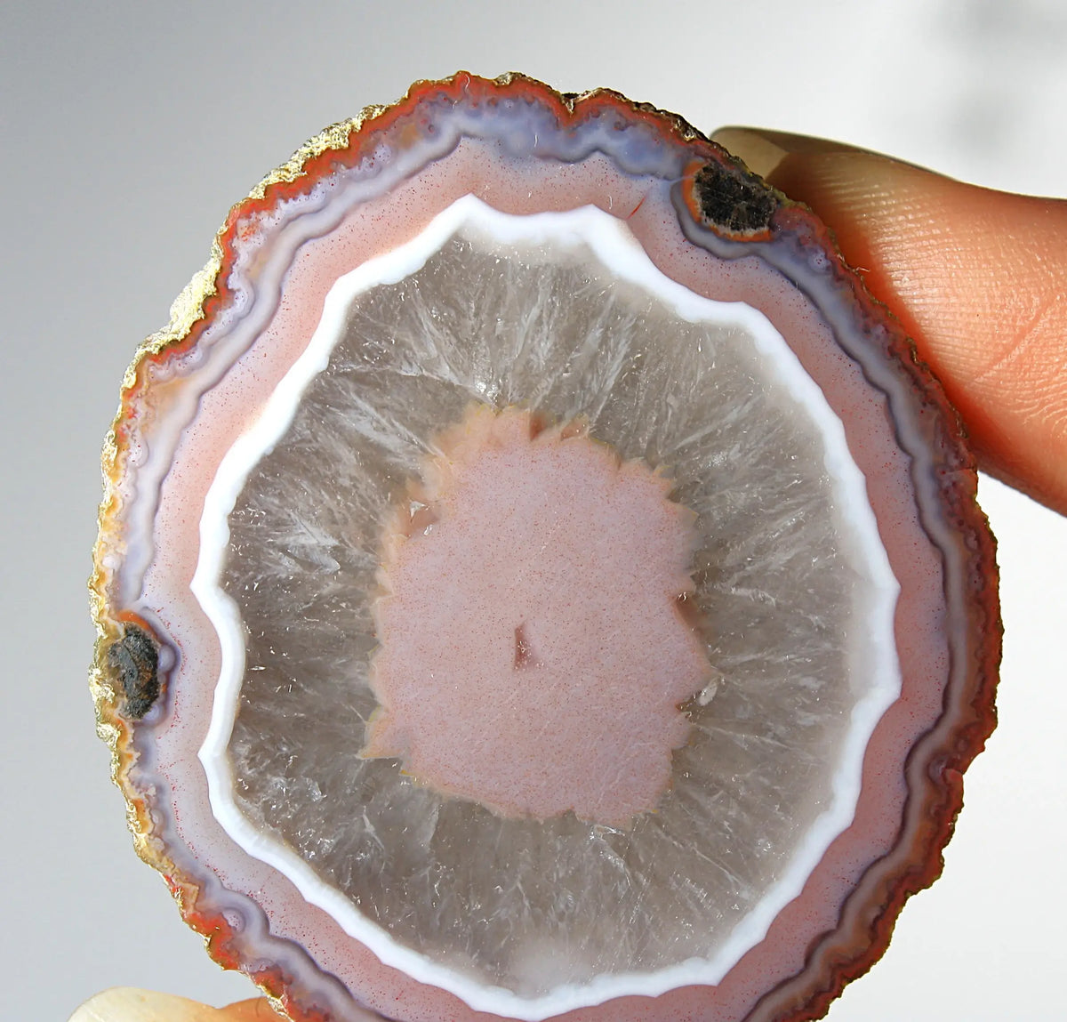 Vibrant pink Zhanguo agate pair with luminous, swirling bands