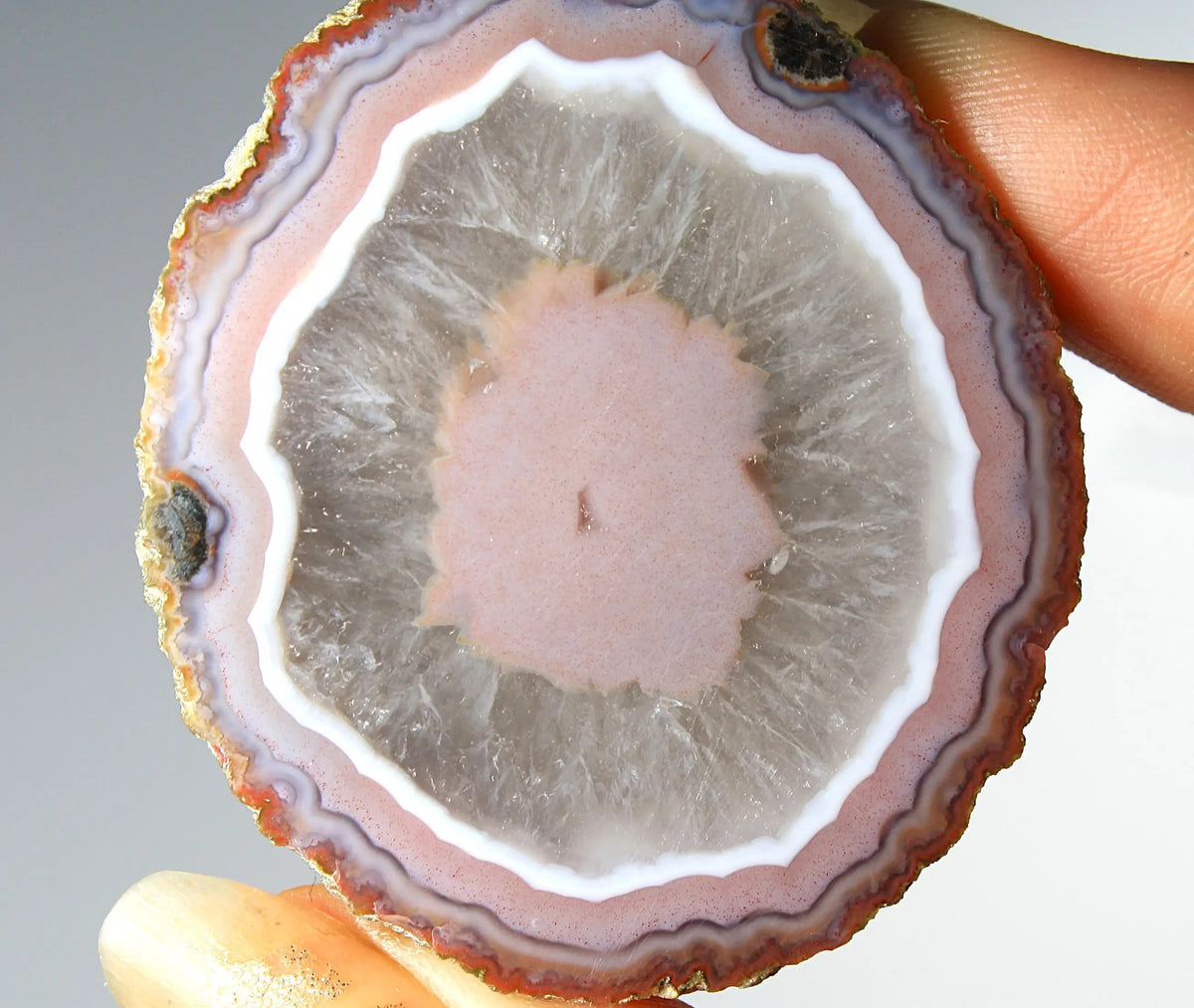 Vibrant pink Zhanguo agate pair with luminous, swirling bands