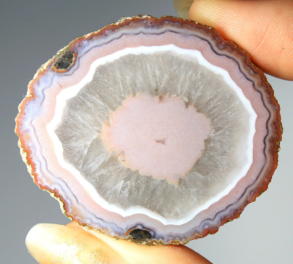 Vibrant pink Zhanguo agate pair with luminous, swirling bands