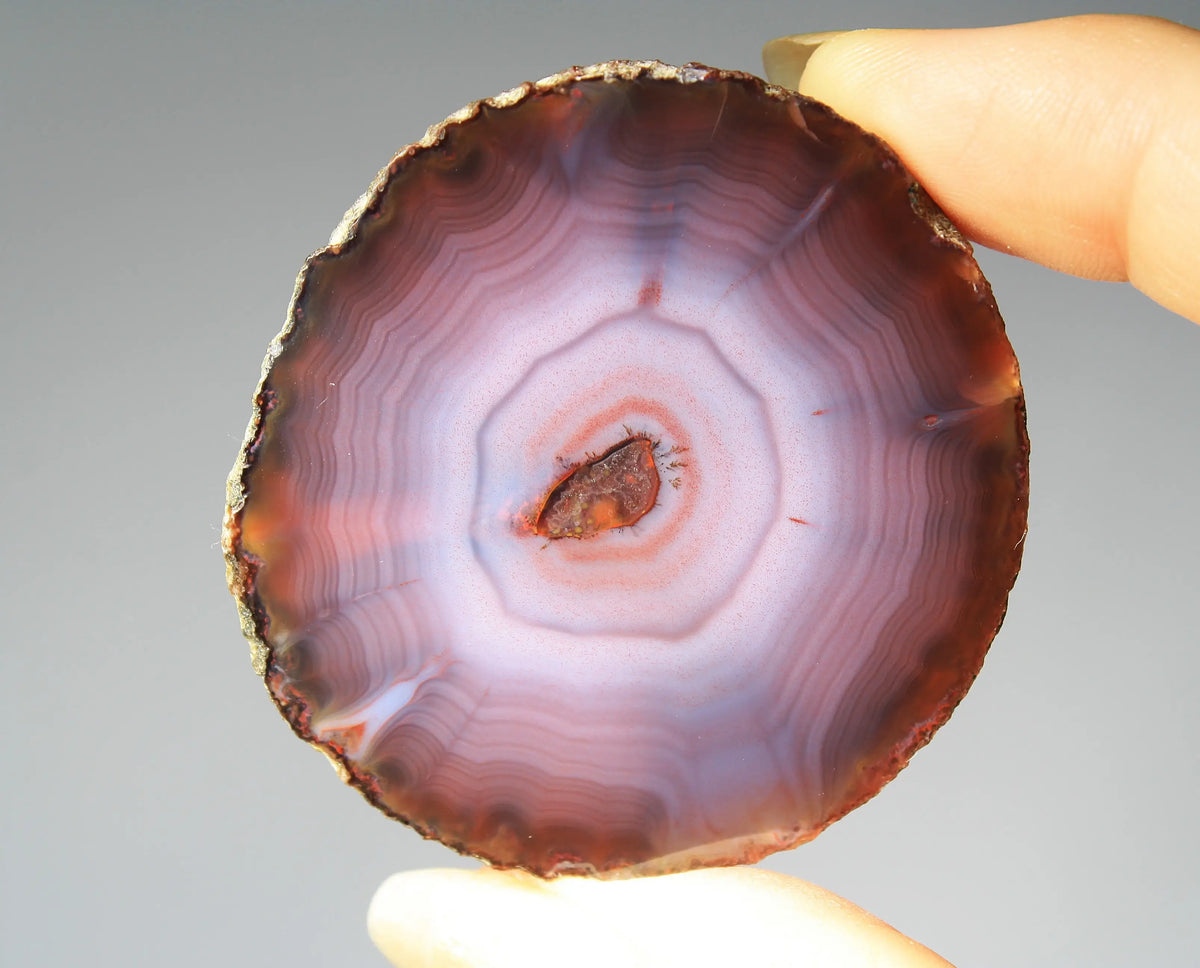 Banded purple Zhanguo agate pair with vivid swirling layers