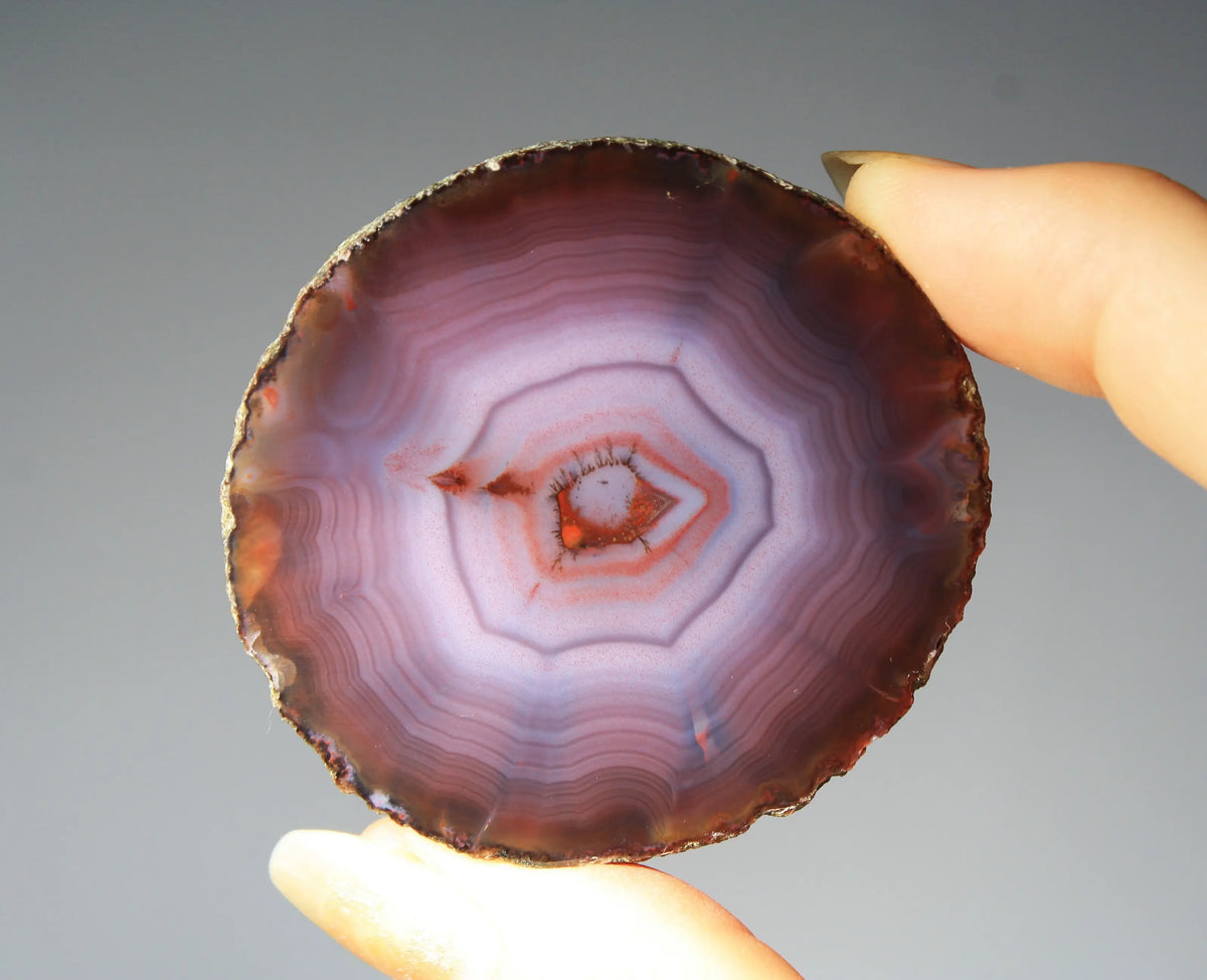 Banded purple Zhanguo agate pair with vivid swirling layers