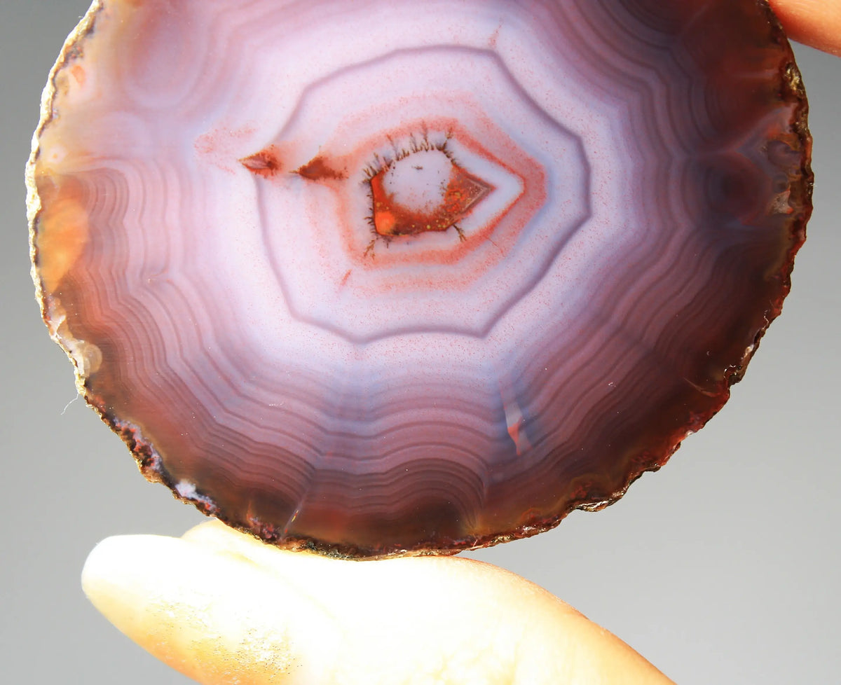 Banded purple Zhanguo agate pair with vivid swirling layers