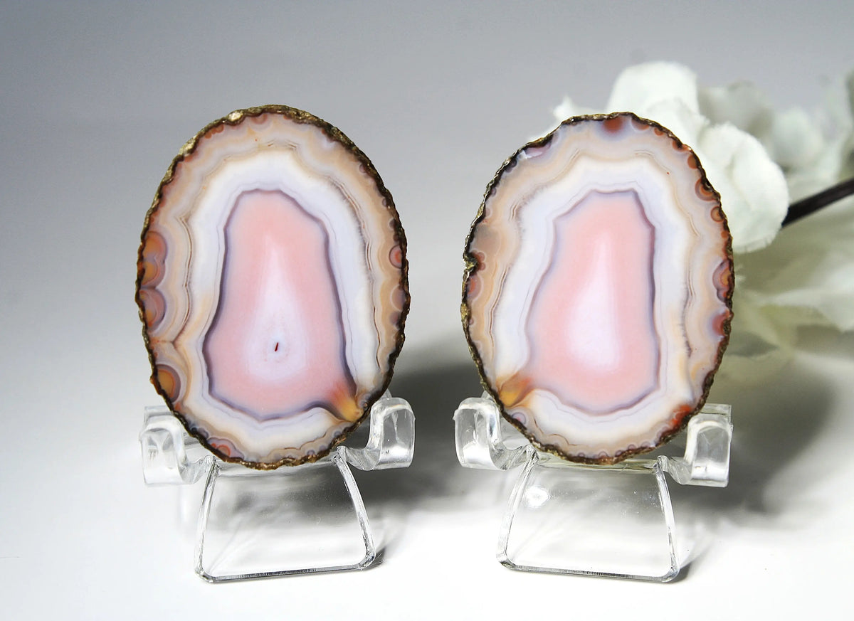 Banded pink Zhanguo agate pair with soft white layer and swirling patterns