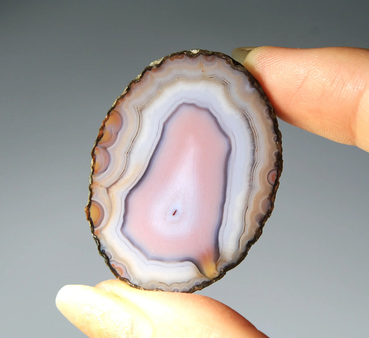 Banded pink Zhanguo agate pair with soft white layer and swirling patterns