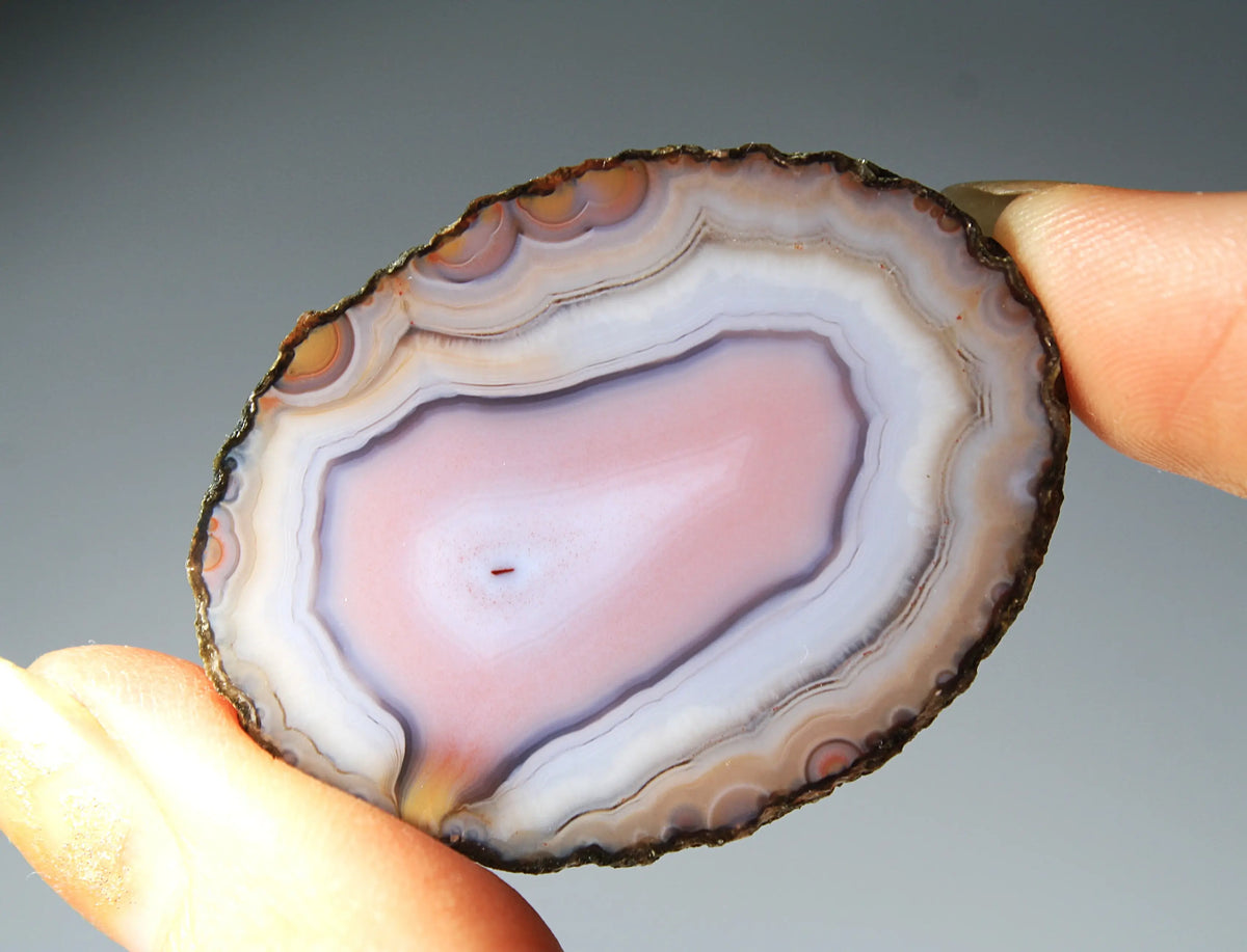 Banded pink Zhanguo agate pair with soft white layer and swirling patterns