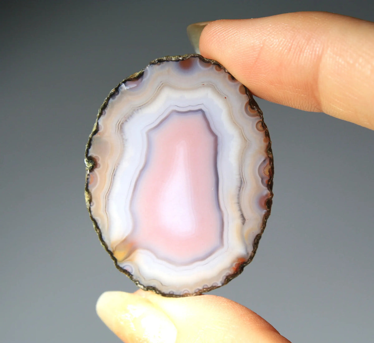 Banded pink Zhanguo agate pair with soft white layer and swirling patterns