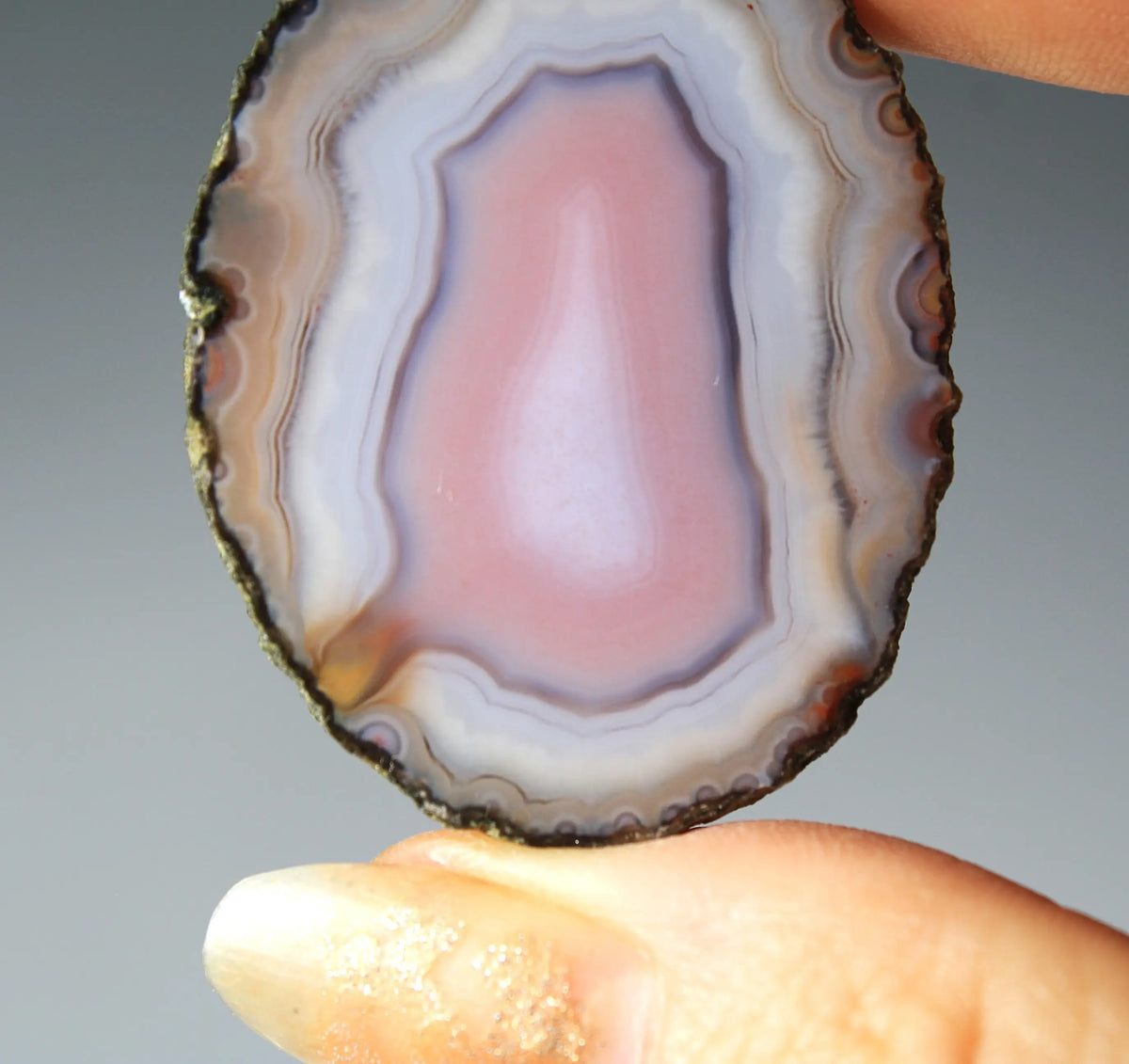 Banded pink Zhanguo agate pair with soft white layer and swirling patterns