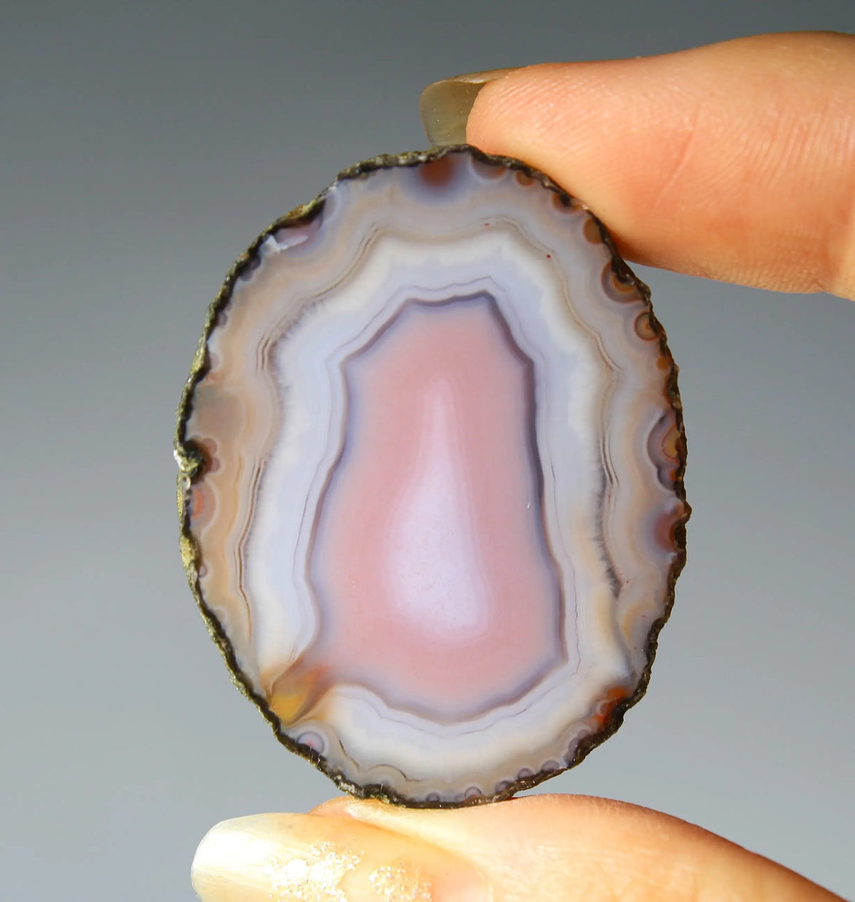 Banded pink Zhanguo agate pair with soft white layer and swirling patterns