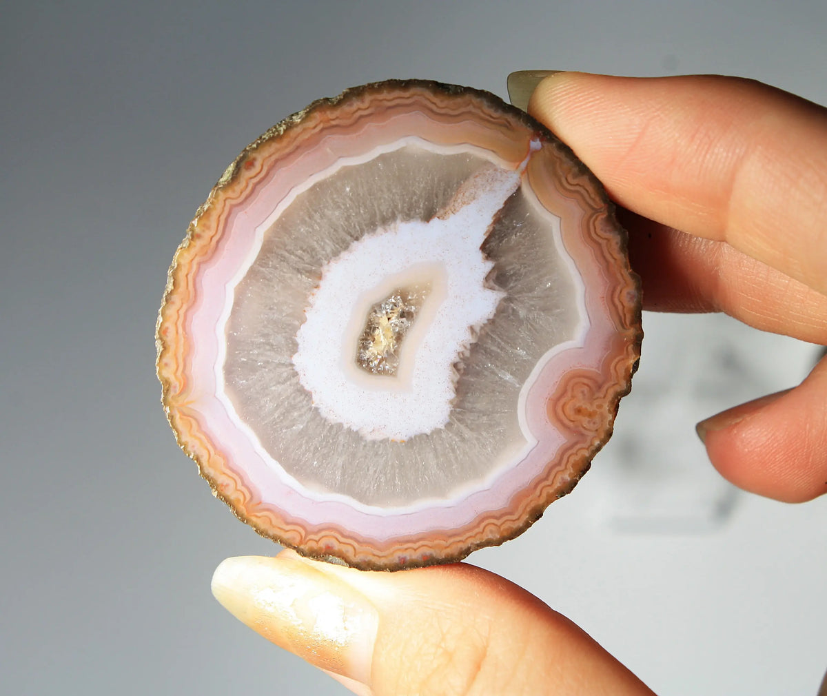 Vibrant pink-orange agate pair with flowing, luminous bands