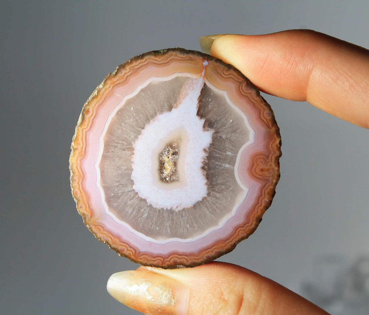 Vibrant pink-orange agate pair with flowing, luminous bands