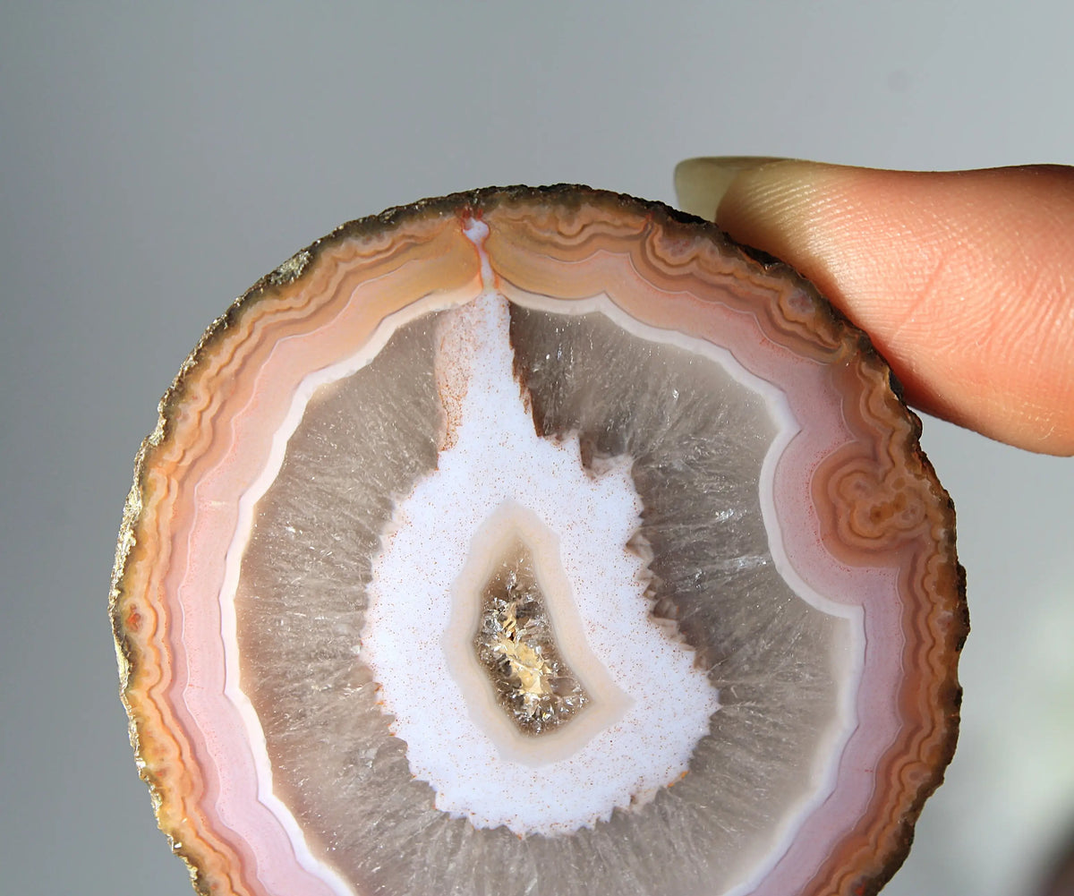 Vibrant pink-orange agate pair with flowing, luminous bands
