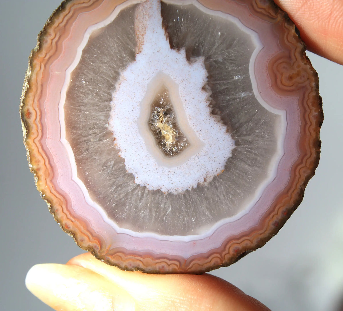 Vibrant pink-orange agate pair with flowing, luminous bands
