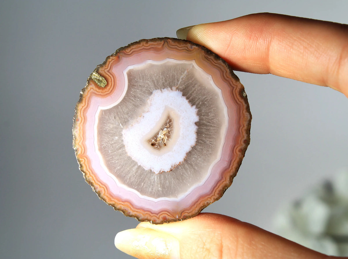 Vibrant pink-orange agate pair with flowing, luminous bands