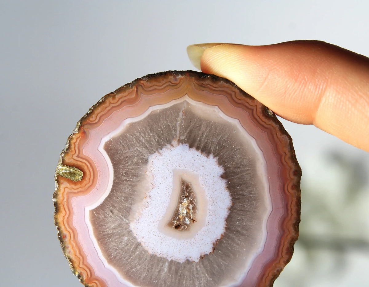 Vibrant pink-orange agate pair with flowing, luminous bands