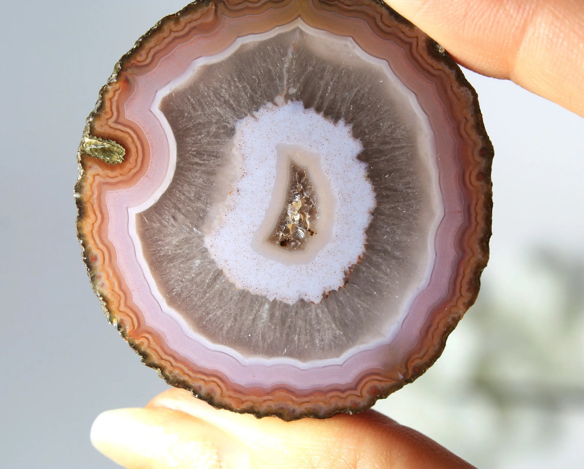 Vibrant pink-orange agate pair with flowing, luminous bands