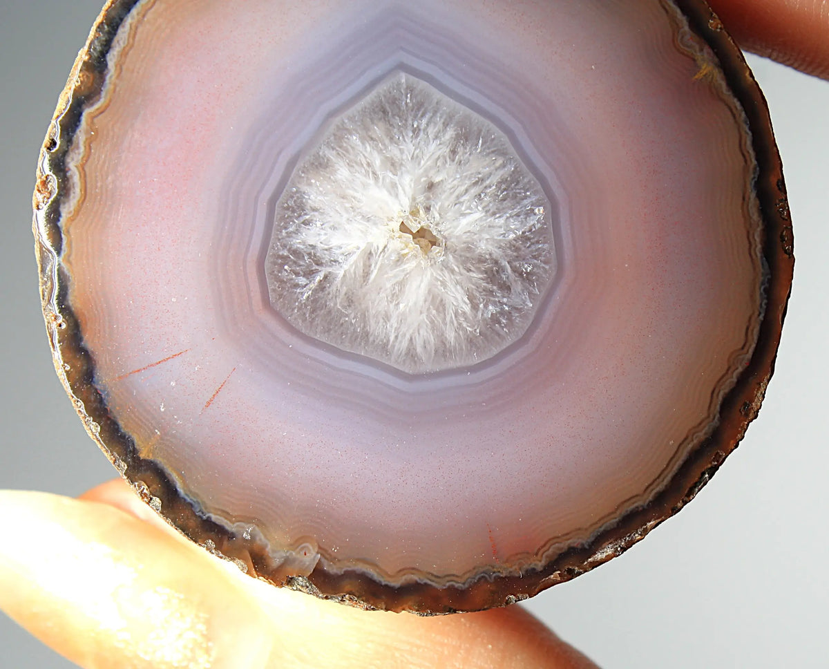 Mystical purple Zhanguo agate pair with layered, luminous patterns