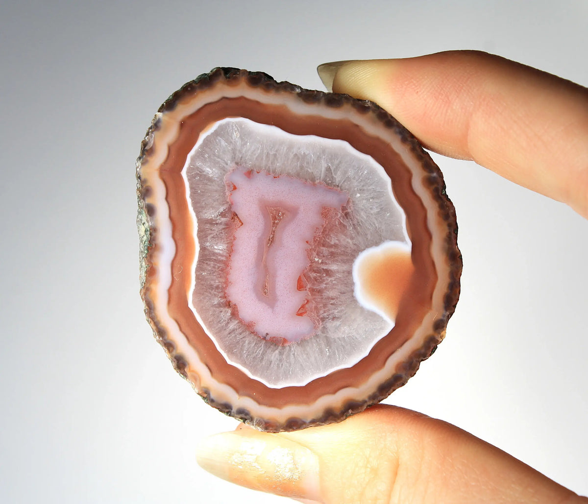 Red and pink Zhanguo agate pair with rich, layered patterns