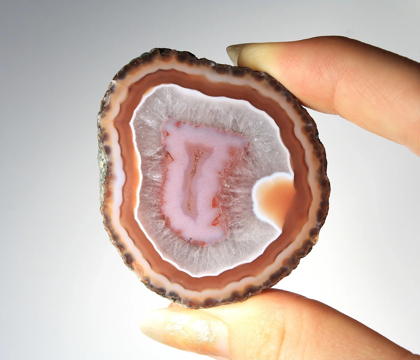 Red and pink Zhanguo agate pair with rich, layered patterns