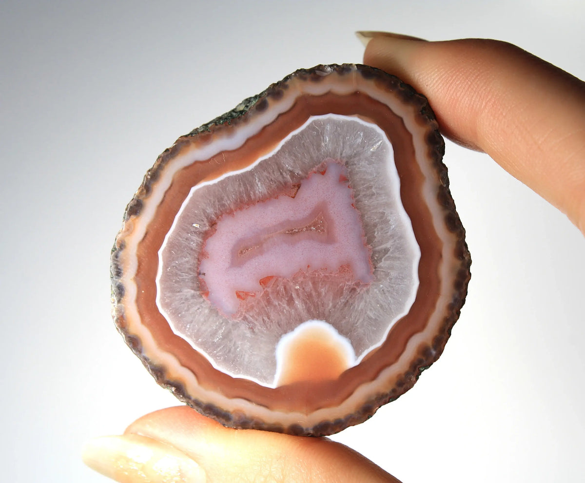 Red and pink Zhanguo agate pair with rich, layered patterns