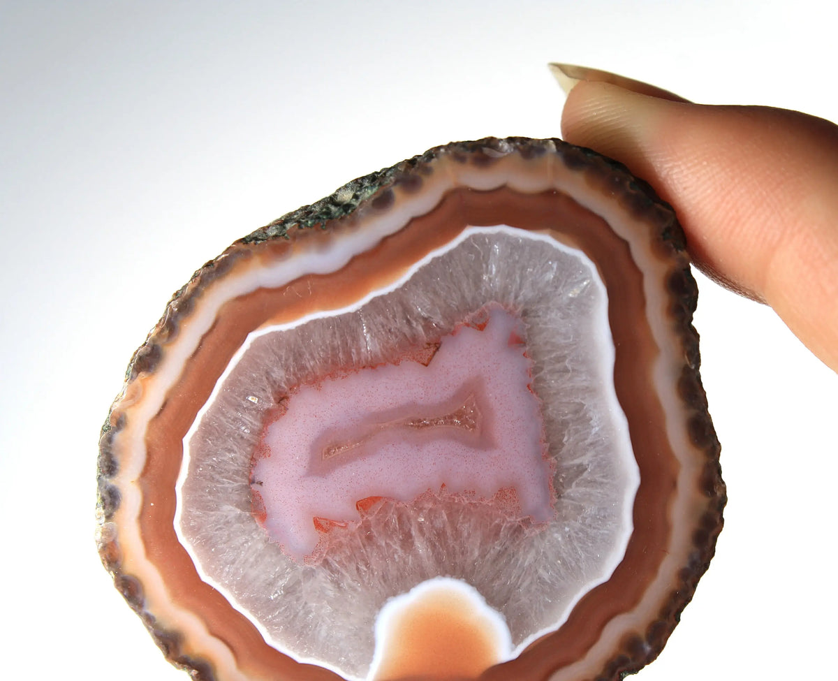 Red and pink Zhanguo agate pair with rich, layered patterns