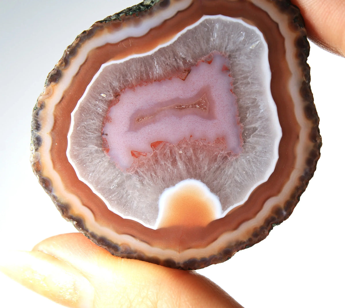 Red and pink Zhanguo agate pair with rich, layered patterns