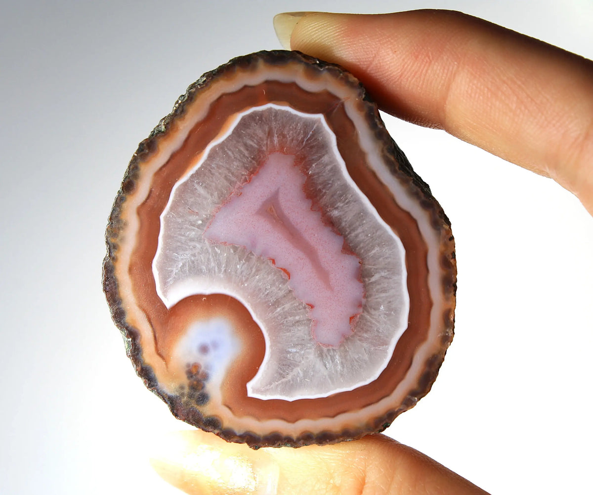 Red and pink Zhanguo agate pair with rich, layered patterns