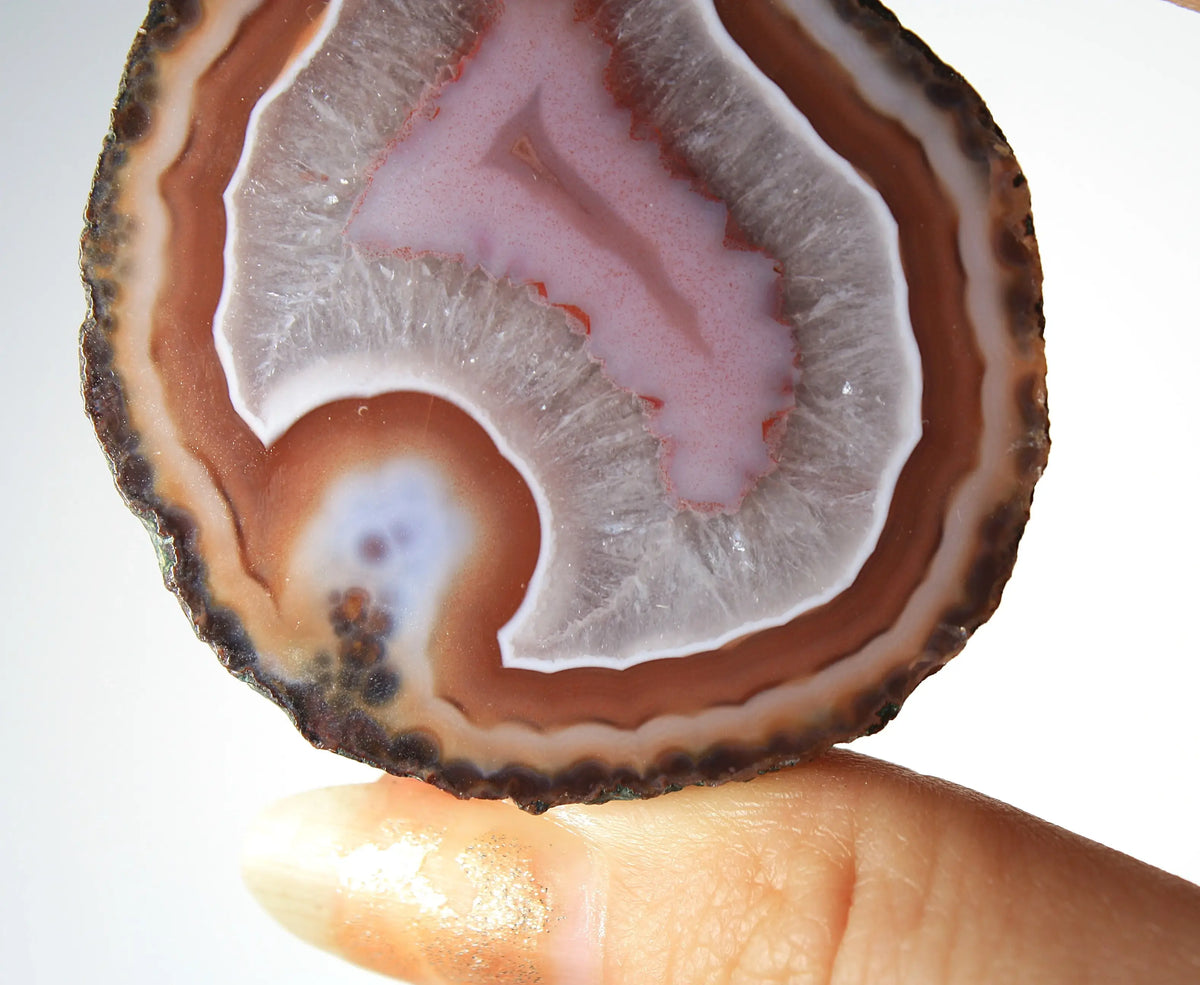 Red and pink Zhanguo agate pair with rich, layered patterns