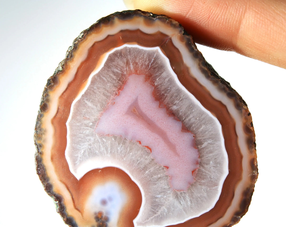 Red and pink Zhanguo agate pair with rich, layered patterns