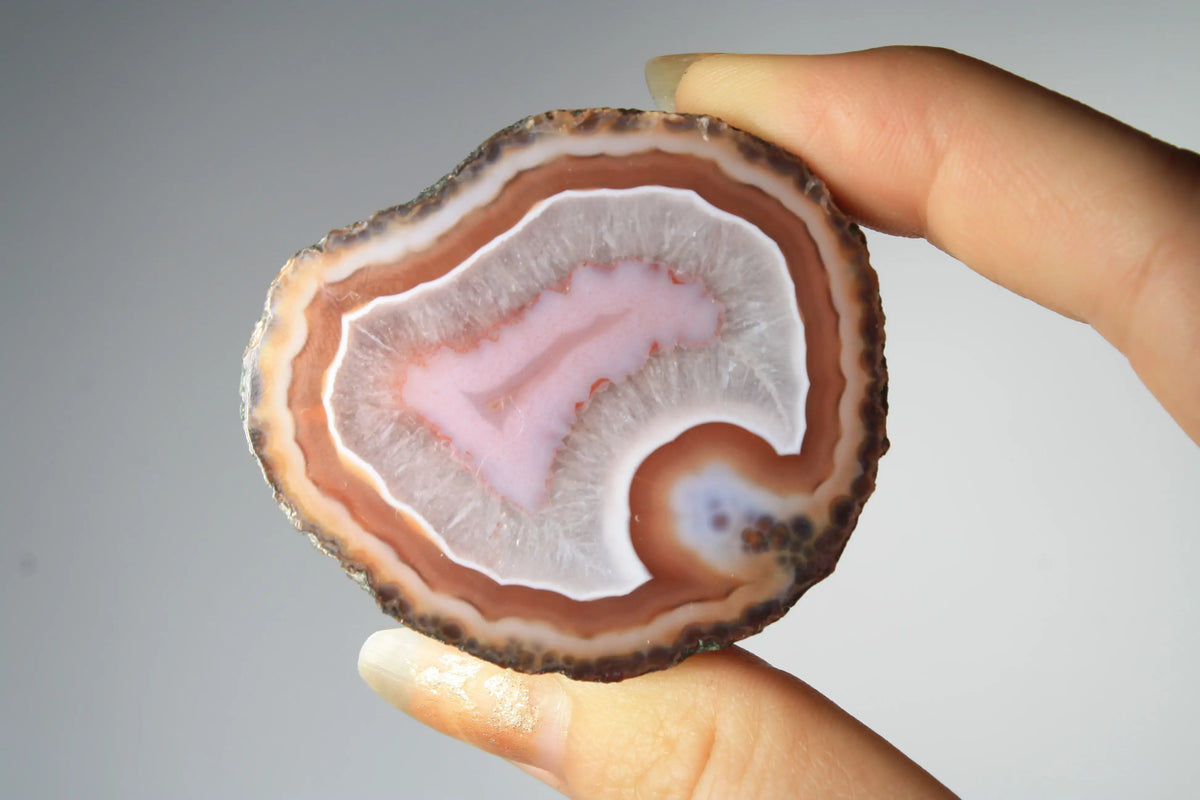 Red and pink Zhanguo agate pair with rich, layered patterns