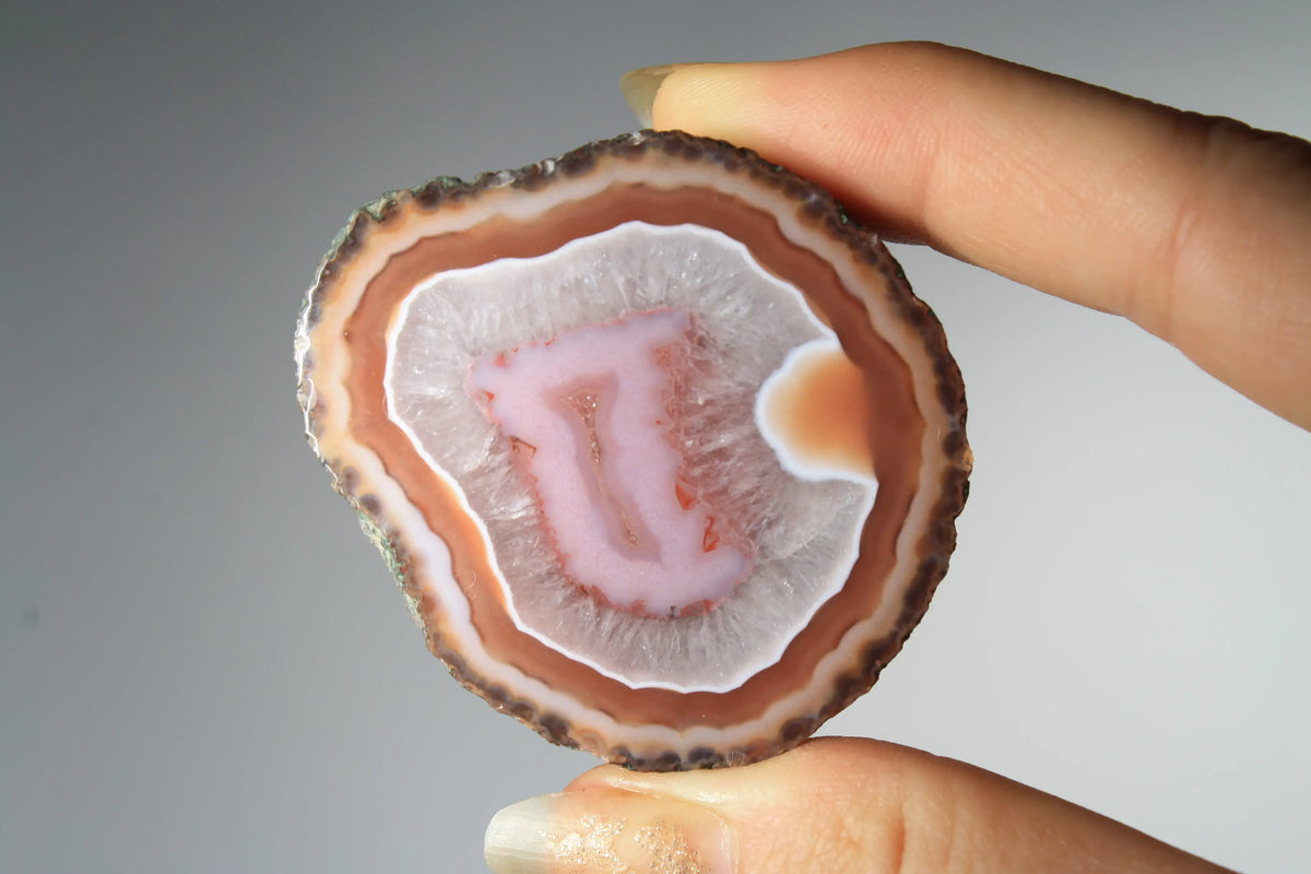 Red and pink Zhanguo agate pair with rich, layered patterns