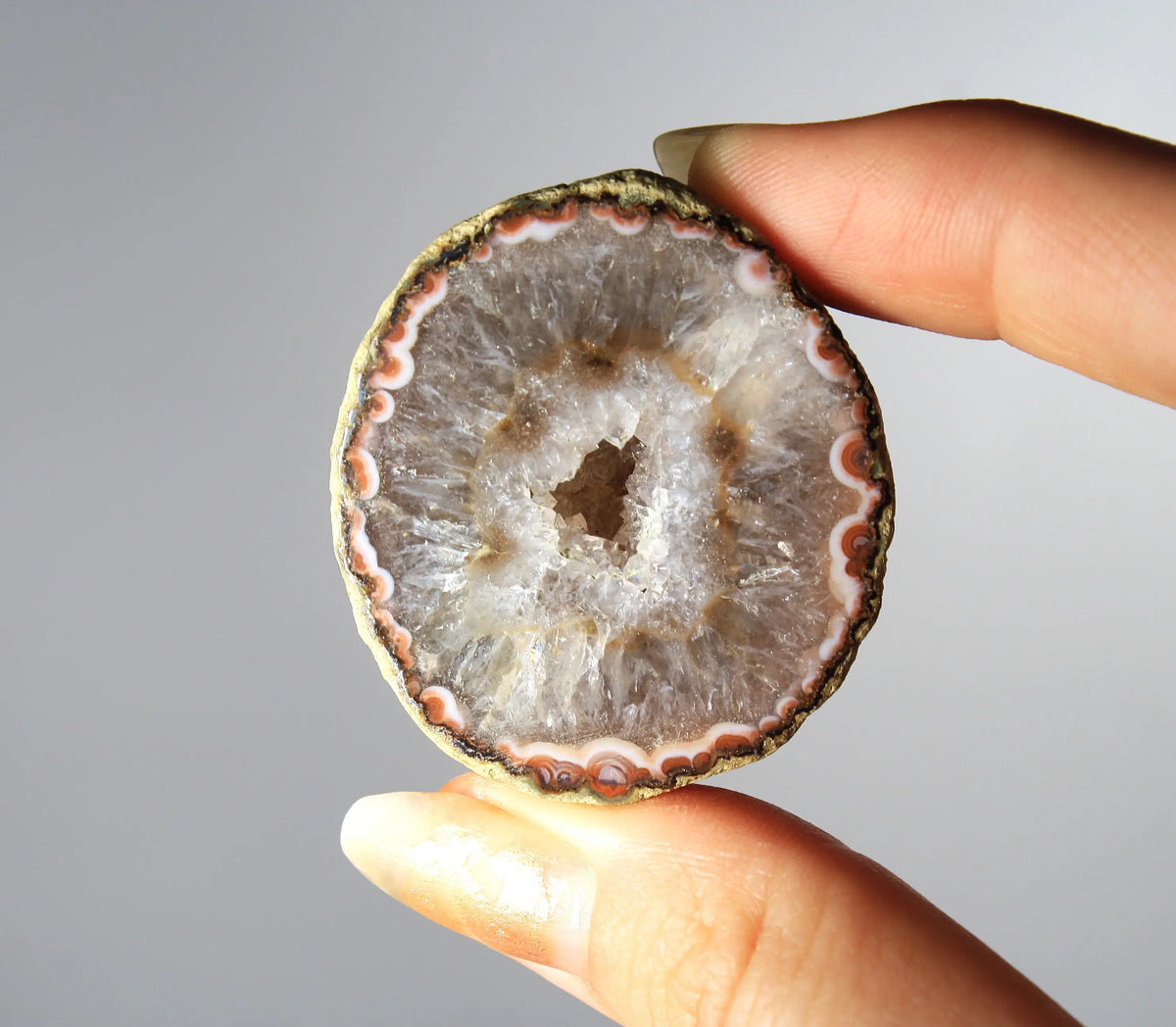 White and orange banded Zhanguo agate pair with a clear crystal core