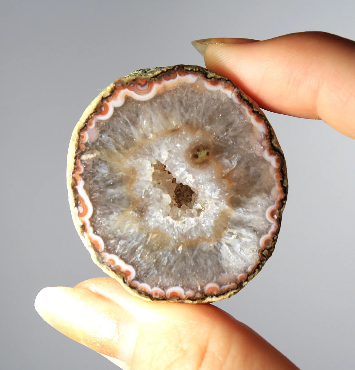 White and orange banded Zhanguo agate pair with a clear crystal core