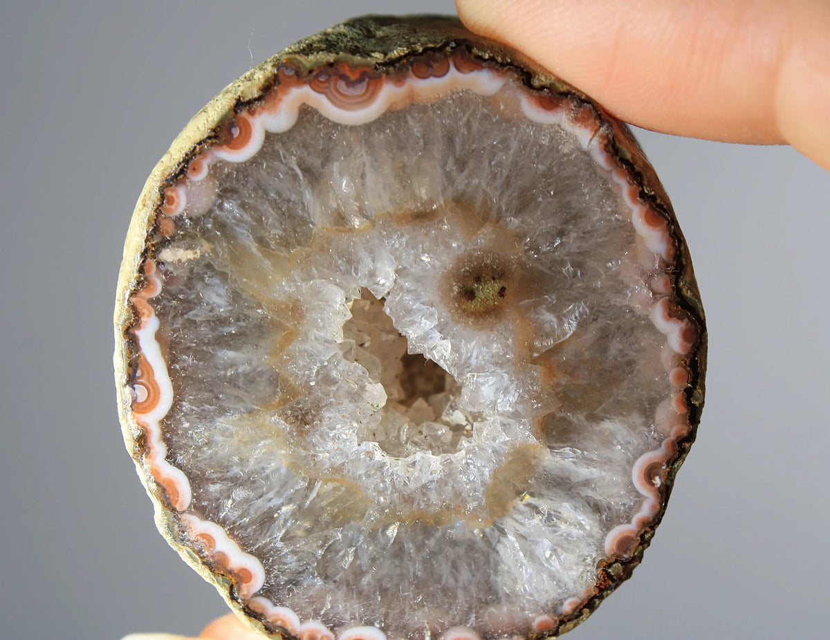 White and orange banded Zhanguo agate pair with a clear crystal core