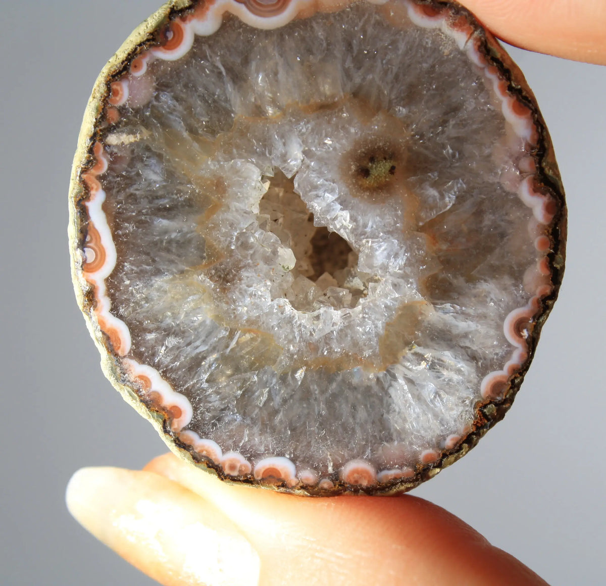 White and orange banded Zhanguo agate pair with a clear crystal core