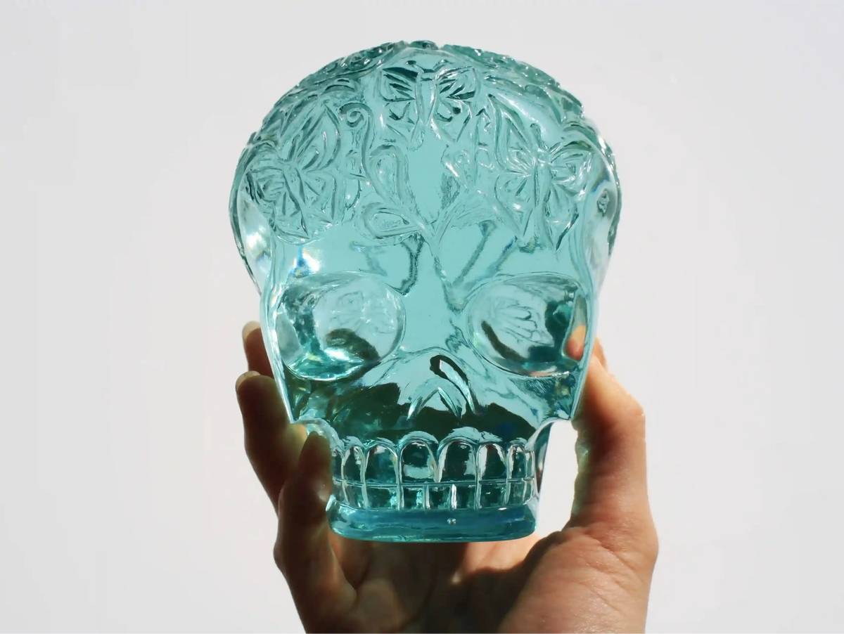 Hand‑carved crystal skull with detailed butterfly engraving by master carver Vikas Meena
