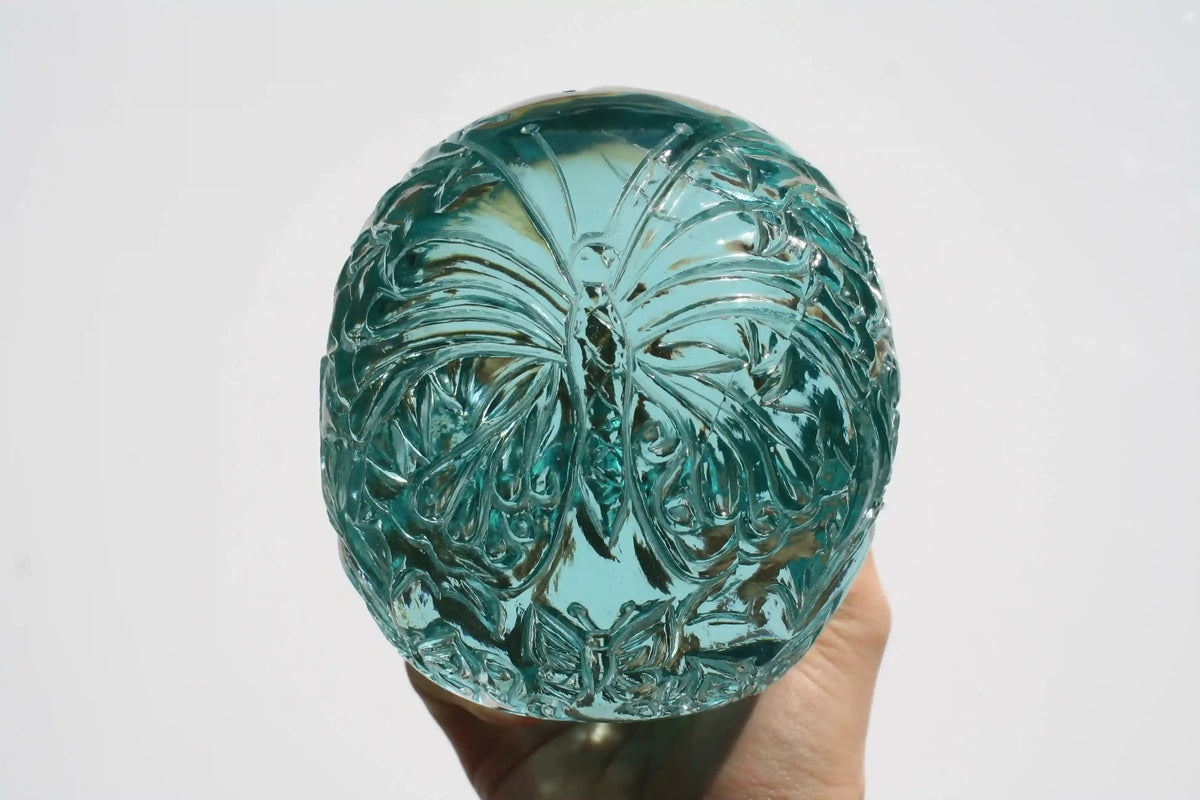 Hand‑carved crystal skull with detailed butterfly engraving by master carver Vikas Meena