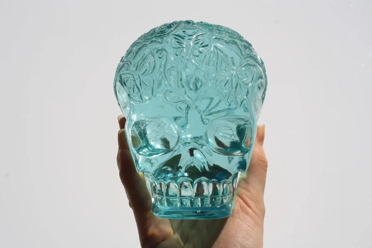 Hand‑carved crystal skull with detailed butterfly engraving by master carver Vikas Meena