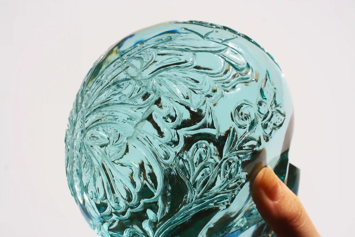 Hand‑carved crystal skull with detailed butterfly engraving by master carver Vikas Meena