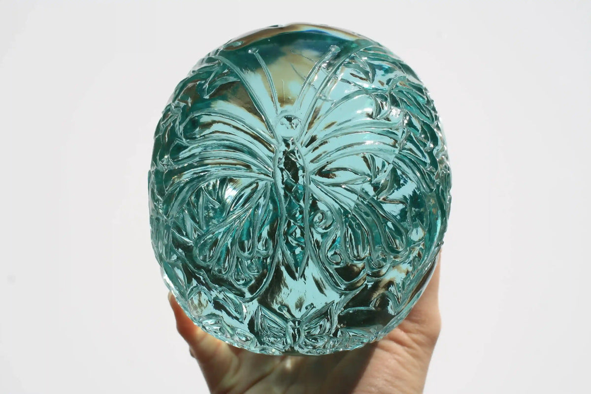 Hand‑carved crystal skull with detailed butterfly engraving by master carver Vikas Meena