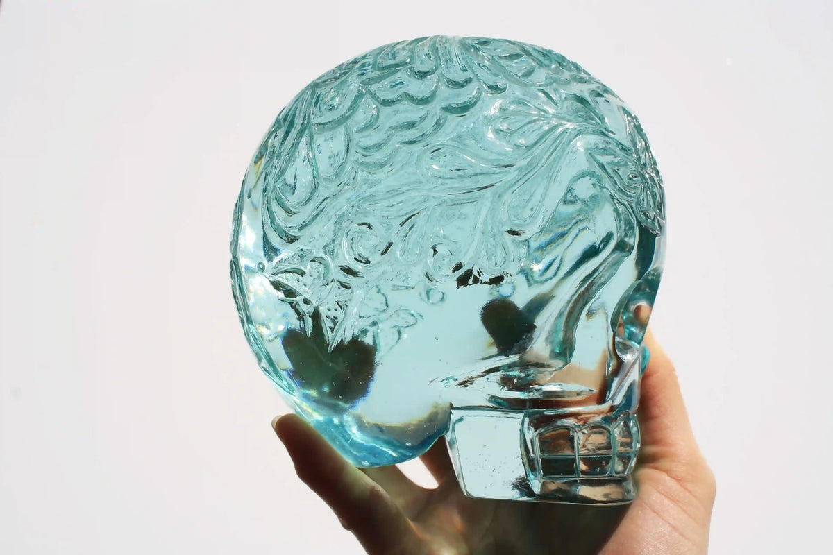 Hand‑carved crystal skull with detailed butterfly engraving by master carver Vikas Meena