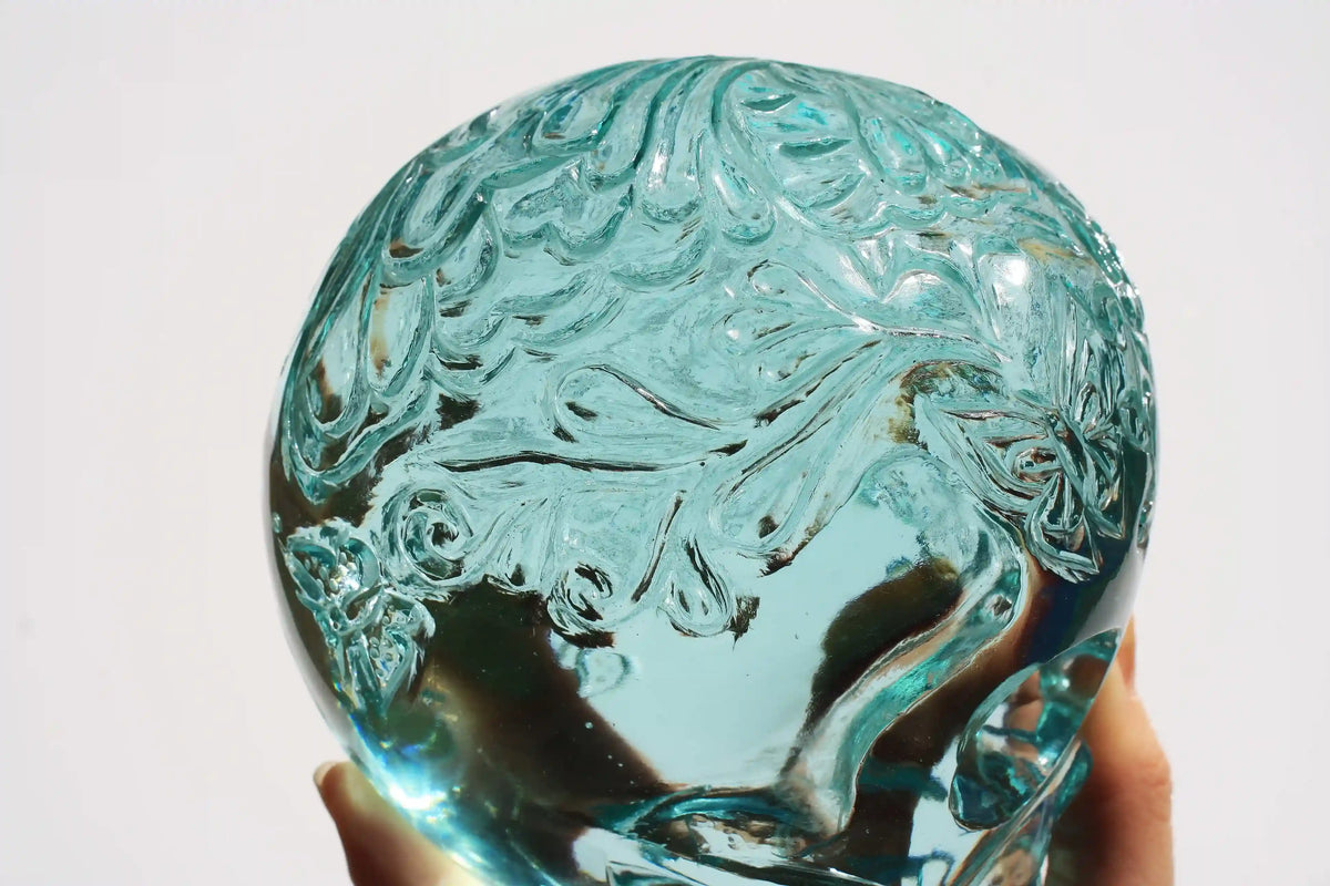 Hand‑carved crystal skull with detailed butterfly engraving by master carver Vikas Meena