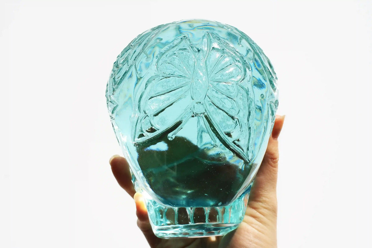 Hand‑carved crystal skull with detailed butterfly engraving by master carver Vikas Meena