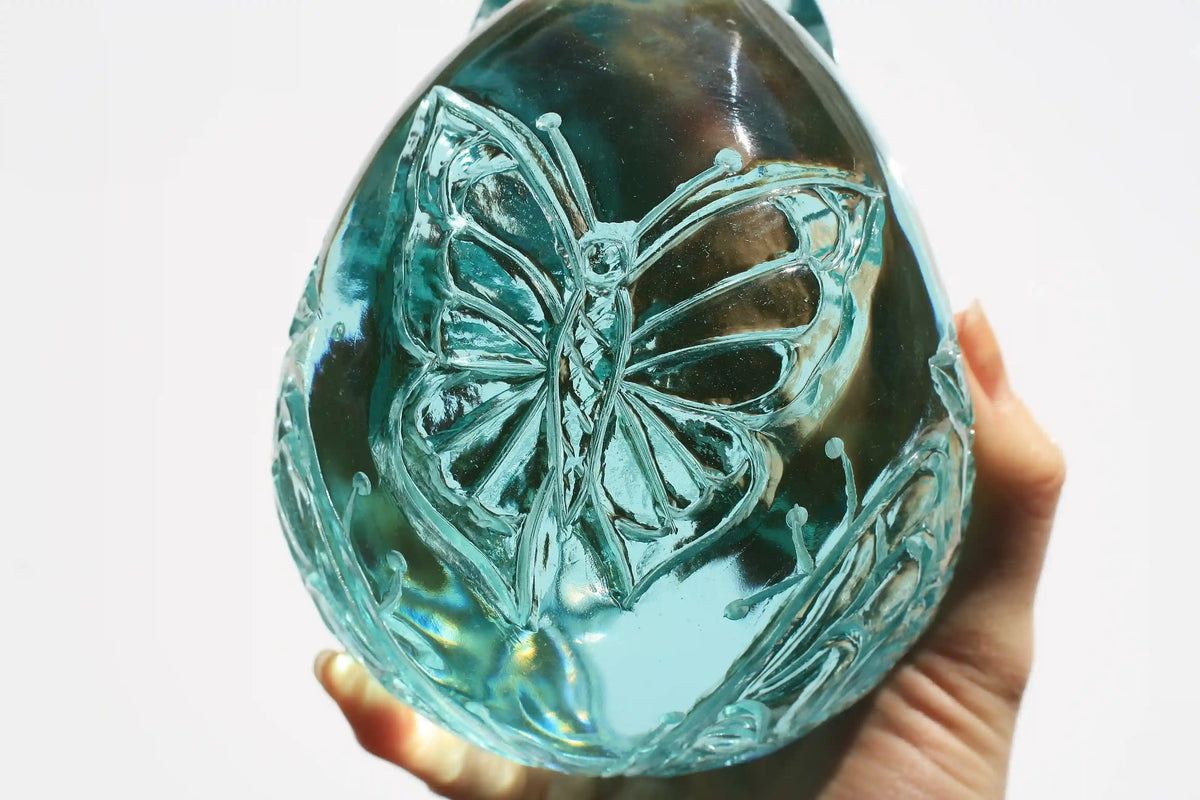 Hand‑carved crystal skull with detailed butterfly engraving by master carver Vikas Meena