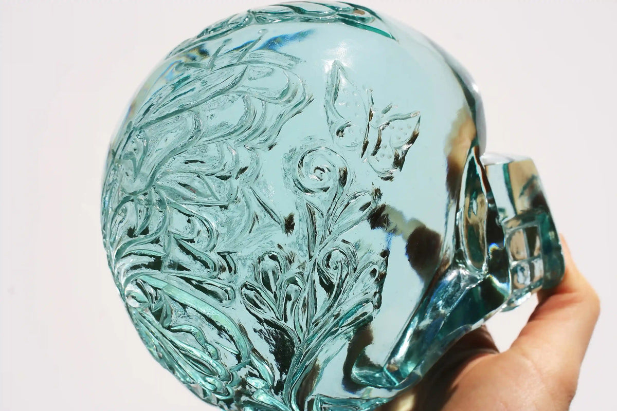 Hand‑carved crystal skull with detailed butterfly engraving by master carver Vikas Meena
