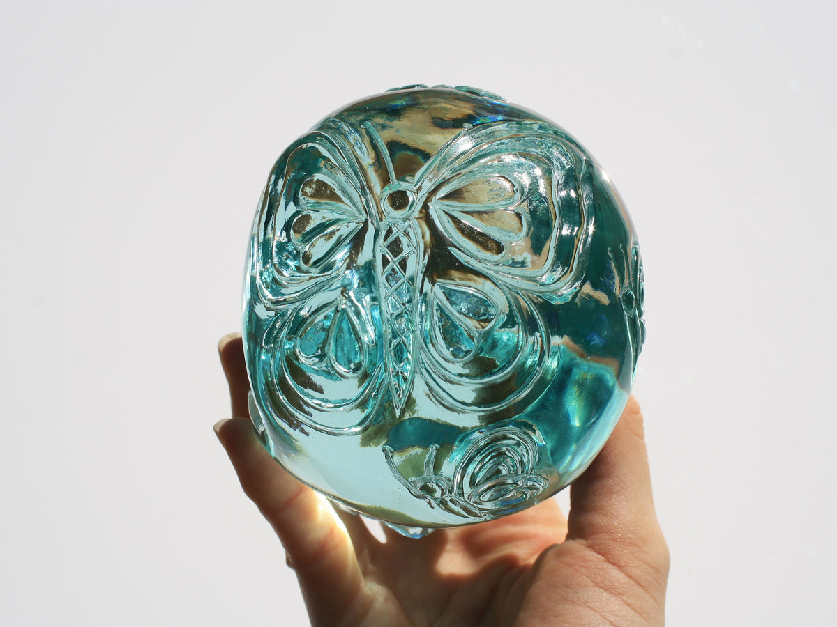 Blue obsidian crystal skull with hand engraved butterfly designs