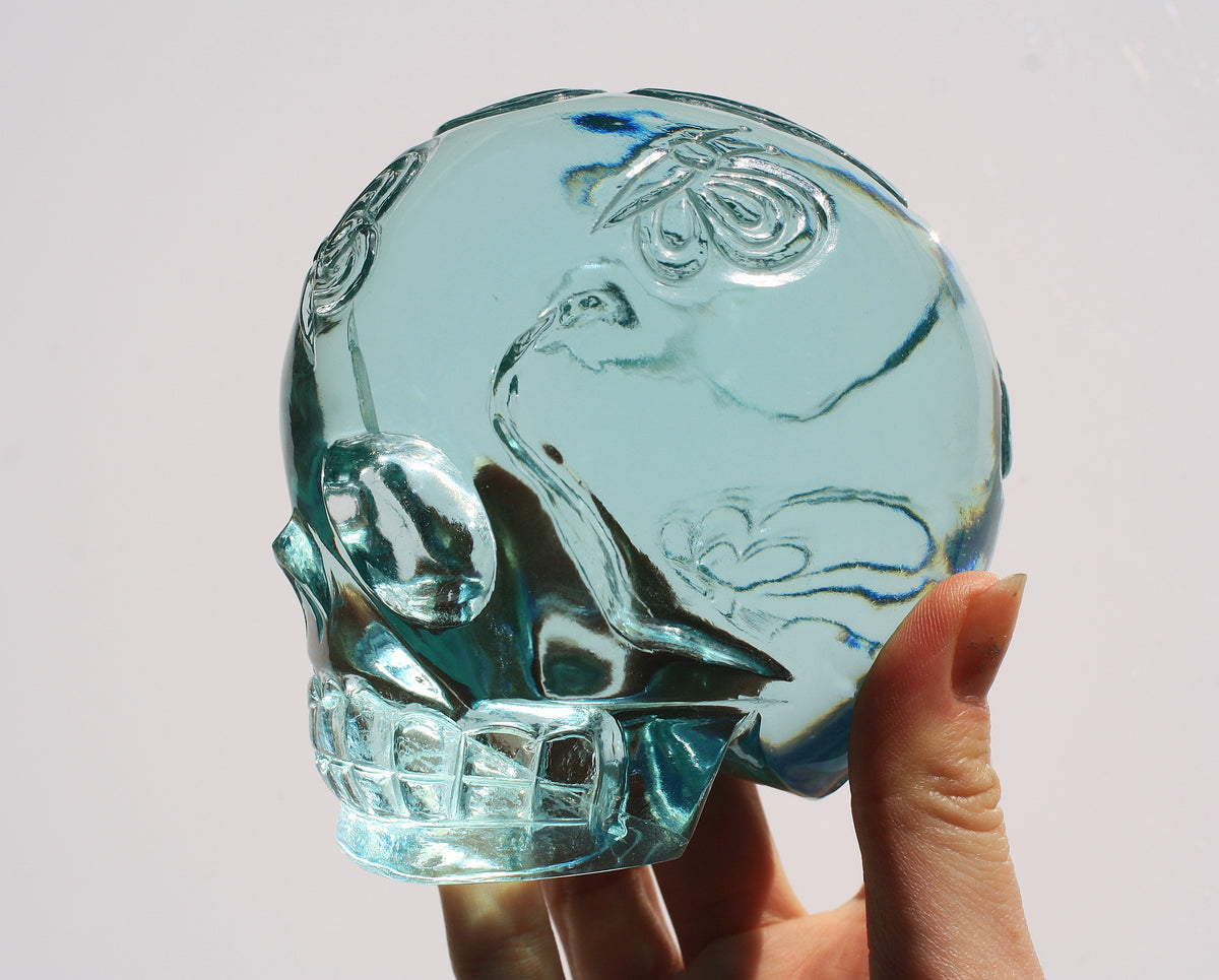 Blue obsidian crystal skull with hand engraved butterfly designs