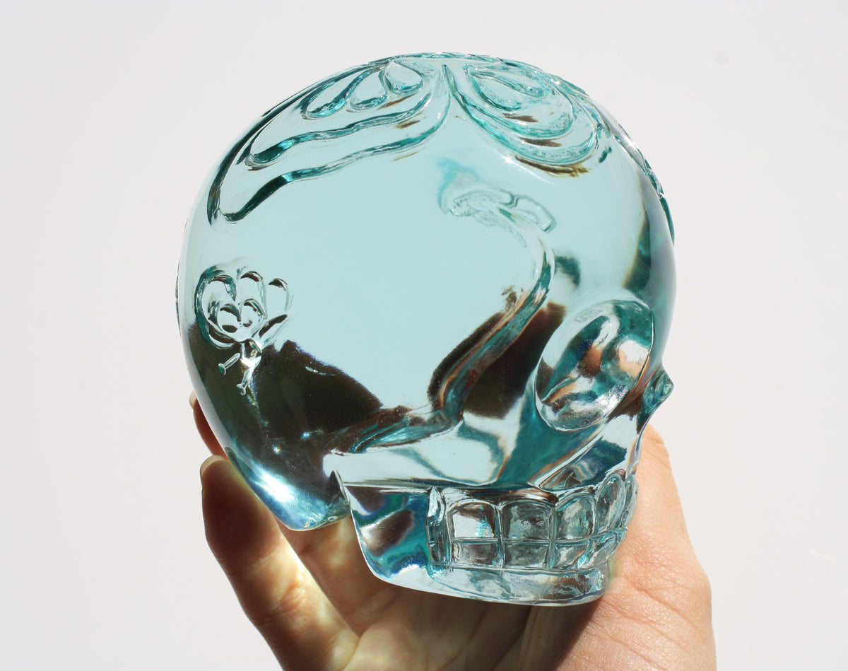 Blue obsidian crystal skull with hand engraved butterfly designs side