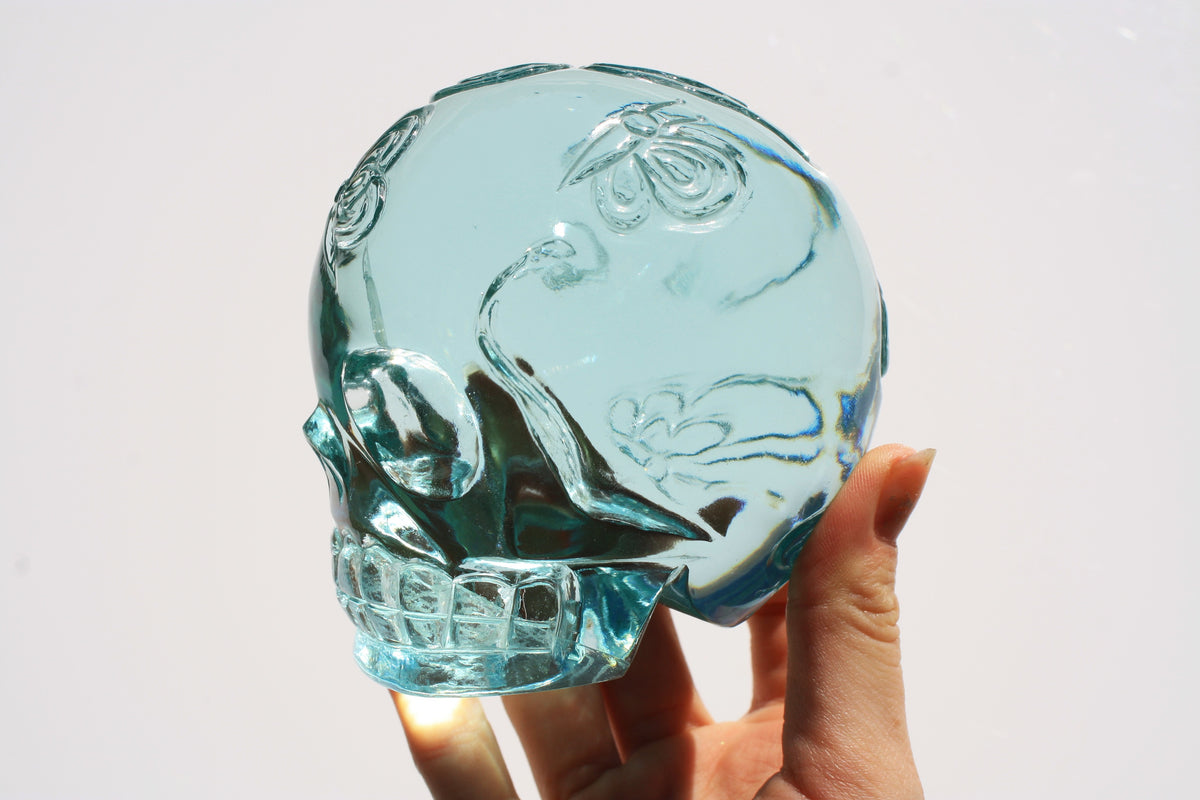 Blue obsidian crystal skull with hand engraved butterfly designs