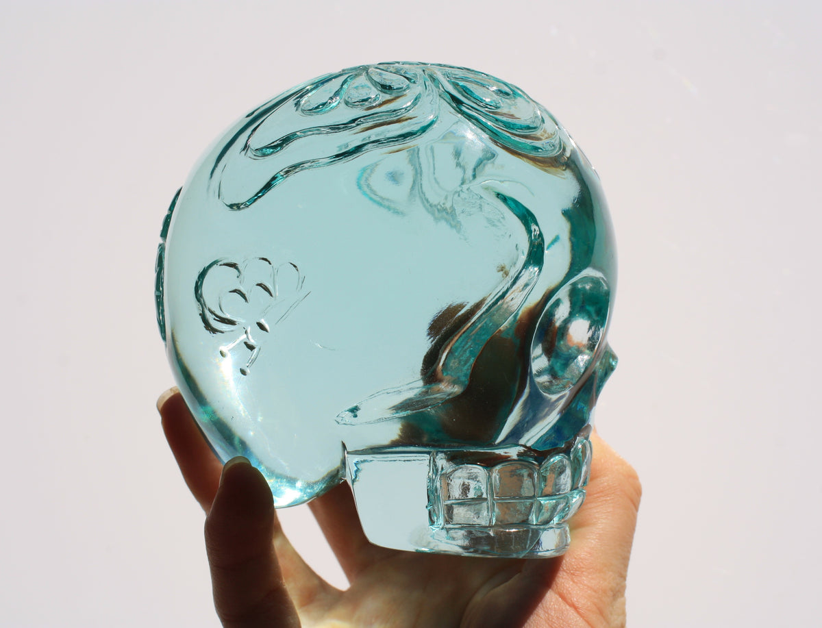 Blue obsidian crystal skull with hand engraved butterfly designs